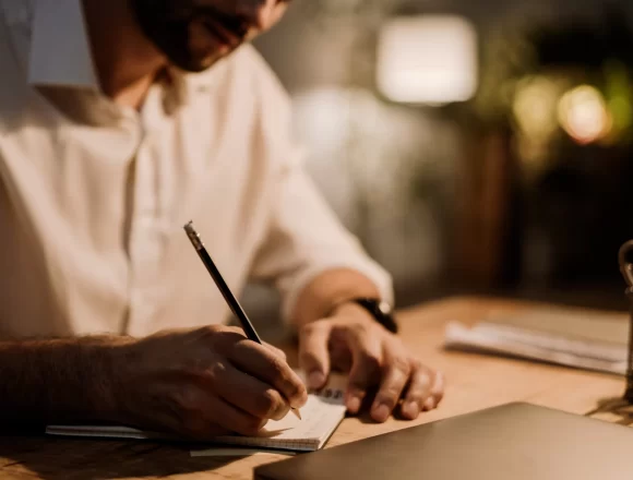 White man writing down notes in planner while working at office 🖋️ La generación Z está matando una habilidad milenaria…